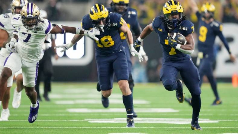 Michigan running back Donovan Edwards (7) runs the ball in for a touchdown in the second quarter during the College Football Playoff national championship game against Washington at NRG Stadium in Houston, Texas on Monday, January 8, 2024.