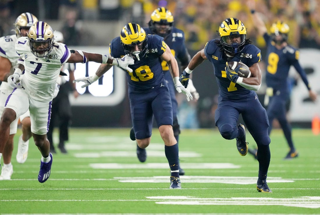 Michigan running back Donovan Edwards (7) runs the ball in for a touchdown in the second quarter during the College Football Playoff national championship game against Washington at NRG Stadium in Houston, Texas on Monday, January 8, 2024.