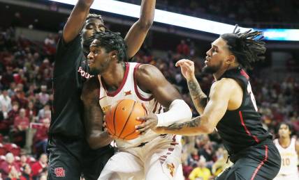 Iowa State Cyclones forward Tre King (0) drives to the basket a between Houston Cougars forward Ja'Vier Francis (5) and guard Emanuel Sharp (21) during the first half in the Big-12 conference showdown of an NCAA college basketball at Hilton Coliseum on Tuesday, Jan. 9, 2024, in Ames, Iowa.