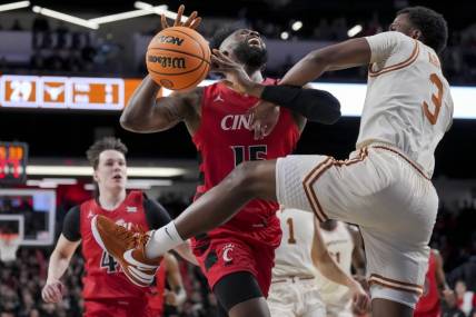 Jan 9, 2024; Cincinnati, Ohio, USA;  Cincinnati Bearcats forward John Newman III (15) reacts as he is fouled by Texas Longhorns guard Max Abmas (3) in the first half at Fifth Third Arena. Mandatory Credit: Aaron Doster-USA TODAY Sports