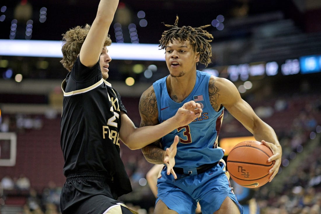 Jan 9, 2024; Tallahassee, Florida, USA; Wake Forest Demon Deacons forward Zach Keller (25) defends a drive by Florida State Seminoles guard Cam Corhen (3) during the first half at Donald L. Tucker Center. Mandatory Credit: Melina Myers-USA TODAY Sports