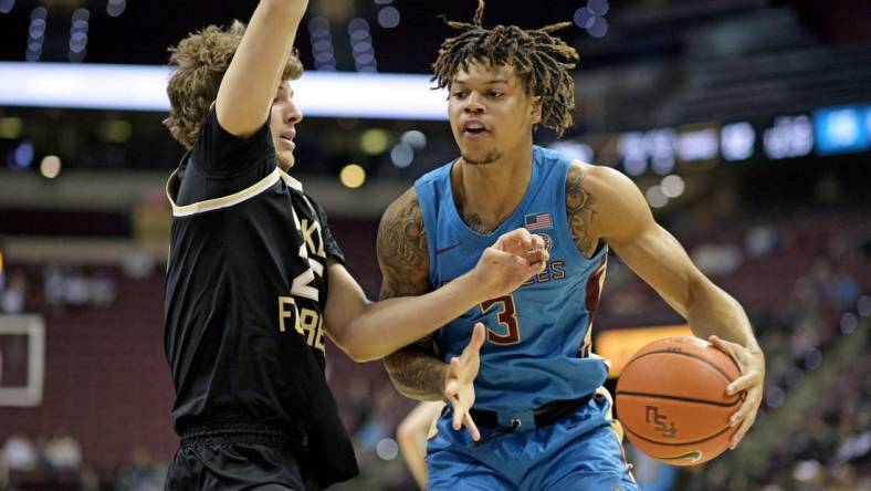 Jan 9, 2024; Tallahassee, Florida, USA; Wake Forest Demon Deacons forward Zach Keller (25) defends a drive by Florida State Seminoles guard Cam Corhen (3) during the first half at Donald L. Tucker Center. Mandatory Credit: Melina Myers-USA TODAY Sports