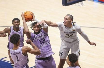 Jan 9, 2024; Morgantown, West Virginia, USA; Kansas State Wildcats forward Will McNair Jr. (13) grabs a rebound over West Virginia Mountaineers forward Patrick Suemnick (24) during the first half at WVU Coliseum. Mandatory Credit: Ben Queen-USA TODAY Sports