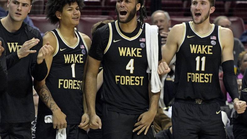 Jan 9, 2024; Tallahassee, Florida, USA; Wake Forest Demon Deacons forwards Marqus Marion (1), Efton Reid III (4), and Andrew Carr (11) react during the second half against the Florida State Seminoles at Donald L. Tucker Center. Mandatory Credit: Melina Myers-USA TODAY Sports