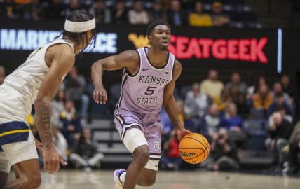 Jan 9, 2024; Morgantown, West Virginia, USA; Kansas State Wildcats guard Cam Carter (5) dribbles the ball during the first half against the West Virginia Mountaineers at WVU Coliseum. Mandatory Credit: Ben Queen-USA TODAY Sports
