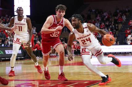 Jan 9, 2024; Piscataway, New Jersey, USA; Rutgers Scarlet Knights guard Austin Williams (24) dribbles against Indiana Hoosiers guard Trey Galloway (32) during the second half at Jersey Mike's Arena. Mandatory Credit: Vincent Carchietta-USA TODAY Sports