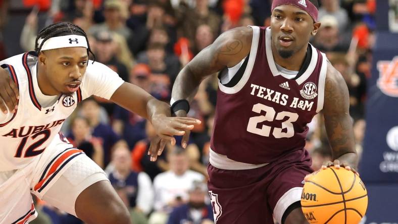 Jan 9, 2024; Auburn, Alabama, USA; Auburn Tigers guard Denver Jones (12) chases Texas A&M Aggies guard Tyrece Radford (23) during the first half at Neville Arena. Mandatory Credit: John Reed-USA TODAY Sports