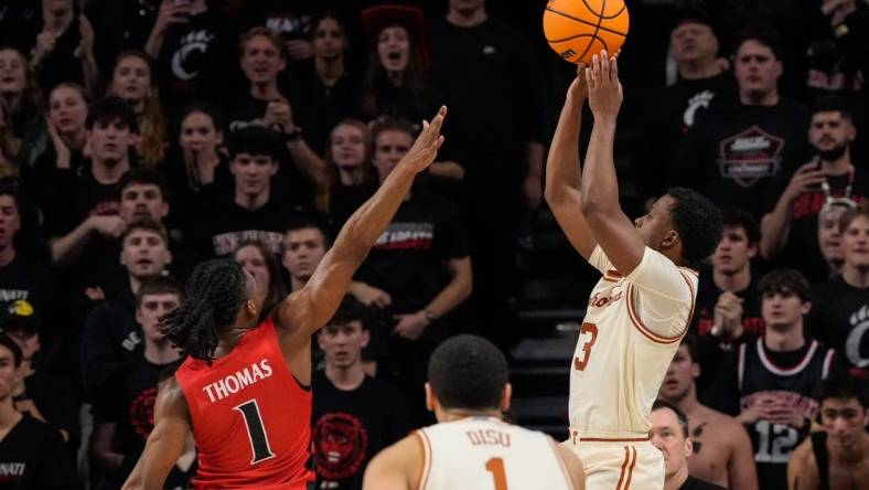 Texas Longhorns guard Max Abmas (3) shoots the go-ahead basket for the win in the second half of the NCAA Big 12 basketball game between the Cincinnati Bearcats and the Texas Longhorns at Fifth Third Arena in Cincinnati on Tuesday, Jan. 9, 2024. Texas pulled off a 74-73 win on a go-ahead basket in the final seconds of the game.