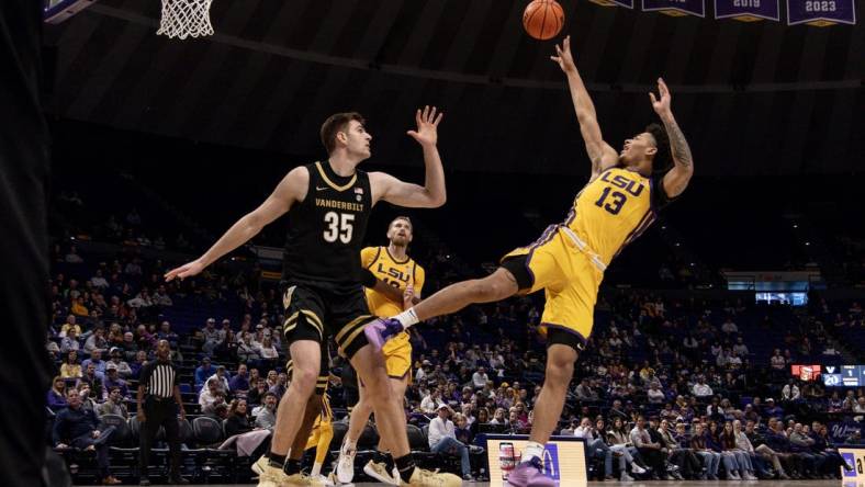 Jan 9, 2024; Baton Rouge, Louisiana, USA; LSU Tigers forward Jalen Reed (13) shoots a jump shot against Vanderbilt Commodores forward Carter Lang (35) during the first half at Pete Maravich Assembly Center. Mandatory Credit: Stephen Lew-USA TODAY Sports