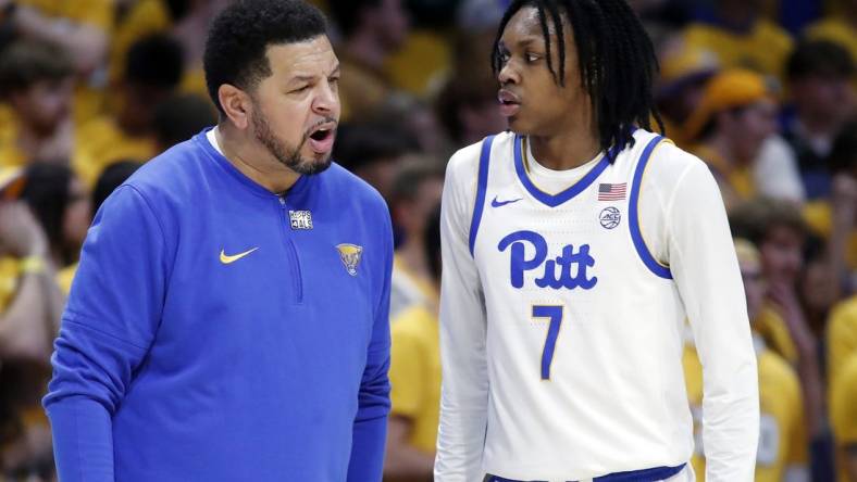 Jan 9, 2024; Pittsburgh, Pennsylvania, USA;  Pittsburgh Panthers head coach Jeff Capel (left) talks with guard Carlton Carrington (7) against the Duke Blue Devils during the first half at the Petersen Events Center. Mandatory Credit: Charles LeClaire-USA TODAY Sports