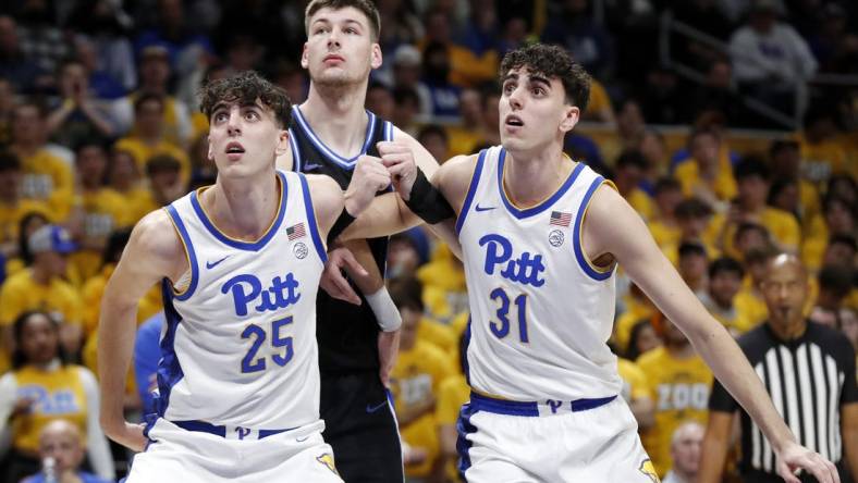 Jan 9, 2024; Pittsburgh, Pennsylvania, USA;  Pittsburgh Panthers twin forwards Guillermo Diaz Graham (25) and Jorge Diaz Graham (31) box out Duke Blue Devils center Kyle Filipowski (middle) during the first half at the Petersen Events Center. Mandatory Credit: Charles LeClaire-USA TODAY Sports