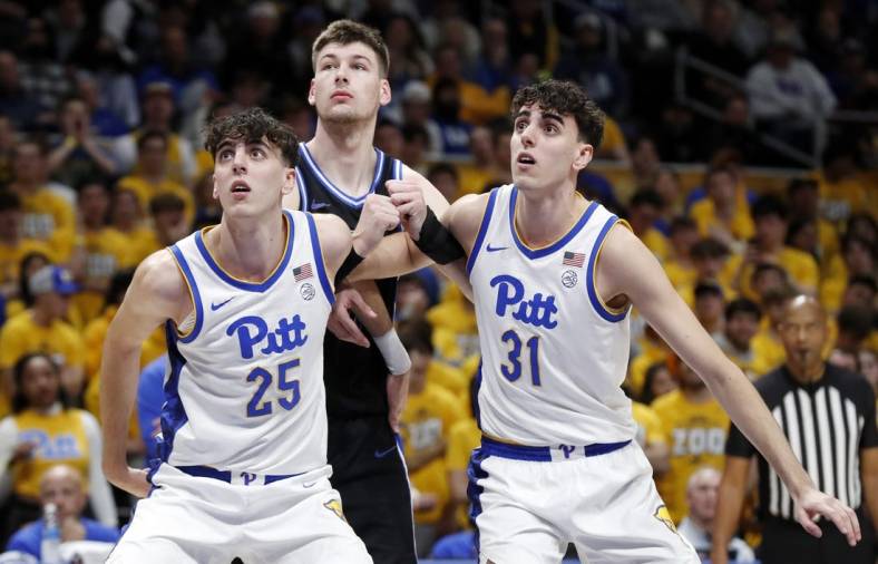 Jan 9, 2024; Pittsburgh, Pennsylvania, USA;  Pittsburgh Panthers twin forwards Guillermo Diaz Graham (25) and Jorge Diaz Graham (31) box out Duke Blue Devils center Kyle Filipowski (middle) during the first half at the Petersen Events Center. Mandatory Credit: Charles LeClaire-USA TODAY Sports
