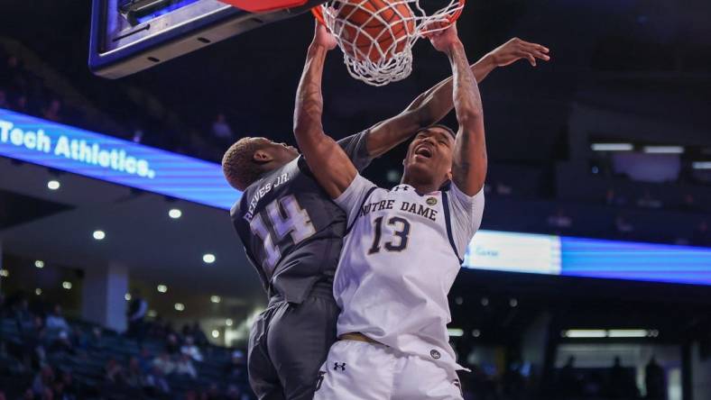 Jan 9, 2024; Atlanta, Georgia, USA; Notre Dame Fighting Irish forward Tae Davis (13) dunks past Georgia Tech Yellow Jackets guard Kowacie Reeves Jr. (14) in the first half at McCamish Pavilion. Mandatory Credit: Brett Davis-USA TODAY Sports