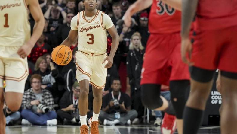 Jan 9, 2024; Cincinnati, Ohio, USA;  Texas Longhorns guard Max Abmas (3) dribbles the ball against the Cincinnati Bearcats in the second half at Fifth Third Arena. Mandatory Credit: Aaron Doster-USA TODAY Sports