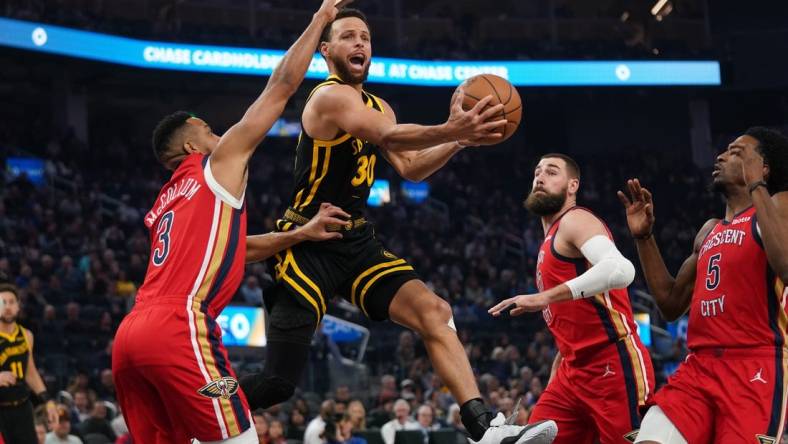 Jan 10, 2024; San Francisco, California, USA; Golden State Warriors guard Stephen Curry (30) attempts a shot next to New Orleans Pelicans guard CJ McCollum (3) in the first quarter at the Chase Center. Mandatory Credit: Cary Edmondson-USA TODAY Sports