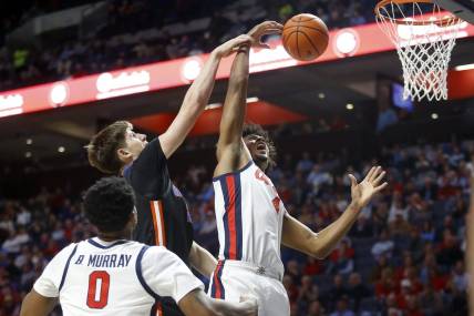 Jan 10, 2024; Oxford, Mississippi, USA; Florida Gators forward/center Alex Condon (21) and Mississippi Rebels forward Jaemyn Brakefield (4) battle for a rebound during the first half at The Sandy and John Black Pavilion at Ole Miss. Mandatory Credit: Petre Thomas-USA TODAY Sports