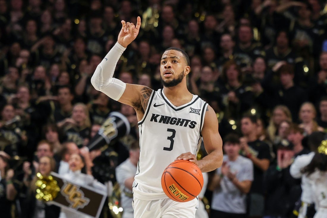 Jan 10, 2024; Orlando, Florida, USA; UCF Knights guard Darius Johnson (3) signals to teammates as he brings the ball up court during the second half against the Kansas Jayhawks at Addition Financial Arena. Mandatory Credit: Mike Watters-USA TODAY Sports