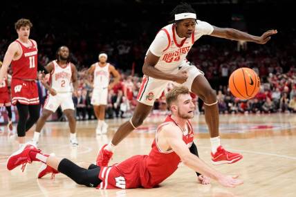 Jan 10, 2024; Columbus, Ohio, USA; Wisconsin Badgers forward Tyler Wahl (5) and Ohio State Buckeyes center Felix Okpara (34) race for a loose ball during the second half of the NCAA men   s basketball game at Value City Arena. Ohio State lost 71-60.