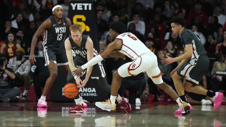 Jan 10, 2024; Los Angeles, California, USA; Washington State Cougars guard Jabe Mullins (3) and Southern California Trojans guard Bronny James (6) reach for the ball in the first half at Galen Center. Mandatory Credit: Kirby Lee-USA TODAY Sports