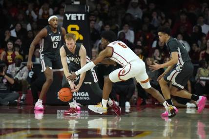 Jan 10, 2024; Los Angeles, California, USA; Washington State Cougars guard Jabe Mullins (3) and Southern California Trojans guard Bronny James (6) reach for the ball in the first half at Galen Center. Mandatory Credit: Kirby Lee-USA TODAY Sports