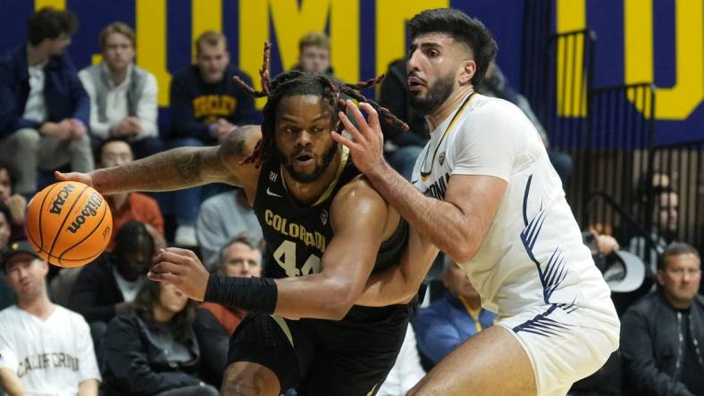 Jan 10, 2024; Berkeley, California, USA; Colorado Buffaloes center Eddie Lampkin Jr. (left) dribbles against California Golden Bears forward Fardaws Aimaq (right) during the first half at Haas Pavilion. Mandatory Credit: Darren Yamashita-USA TODAY Sports