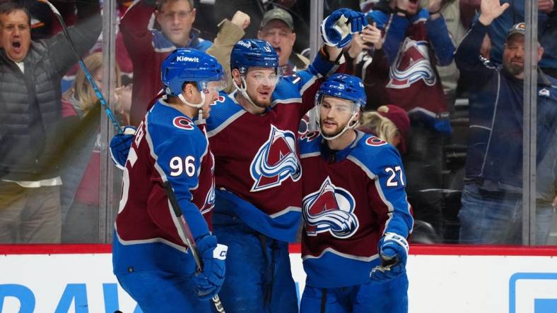 Jan 10, 2024; Denver, Colorado, USA; Colorado Avalanche right wing Valeri Nichushkin (13) celebrates his goal with right wing Mikko Rantanen (96) and left wing Jonathan Drouin (27) in the second period against the Vegas Golden Knights at Ball Arena. Mandatory Credit: Ron Chenoy-USA TODAY Sports