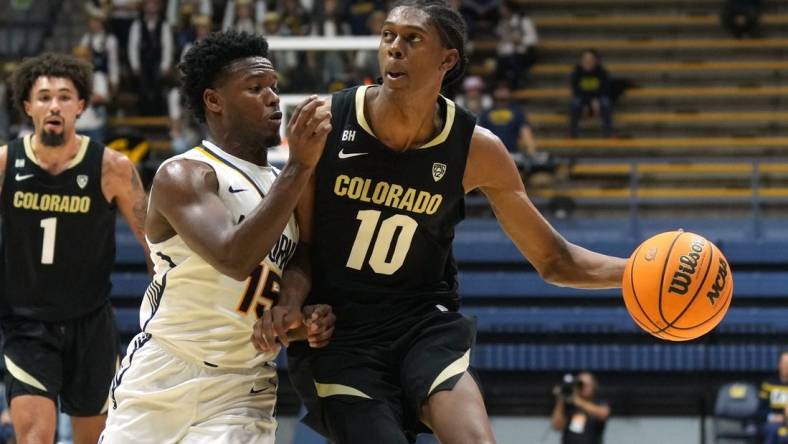 Jan 10, 2024; Berkeley, California, USA; Colorado Buffaloes forward Cody Williams (10) dribbles against California Golden Bears guard Jalen Cone (15) during the first half at Haas Pavilion. Mandatory Credit: Darren Yamashita-USA TODAY Sports