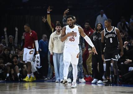 Jan 11, 2024; Paris, FRANCE; Cleveland Cavaliers guard Donovan Mitchell (45) celebrates a three pointer against the Brooklyn Nets in the NBA Paris Game at AccorHotels Arena. Mandatory Credit:  Alexis Reau/Presse Sports via USA TODAY Sports