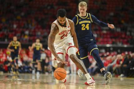 Jan 11, 2024; College Park, Maryland, USA;  Maryland Terrapins forward Donta Scott (24) runs down a loose ball in the backcourt as Michigan Wolverines forward Youssef Khayat (24) chases during the first half at Xfinity Center. Mandatory Credit: Tommy Gilligan-USA TODAY Sports