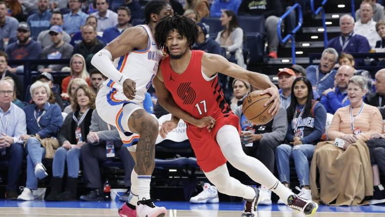 Jan 11, 2024; Oklahoma City, Oklahoma, USA; Portland Trail Blazers guard Shaedon Sharpe (17) drives around Oklahoma City Thunder forward Jalen Williams (8) during the second quarter at Paycom Center. Mandatory Credit: Alonzo Adams-USA TODAY Sports