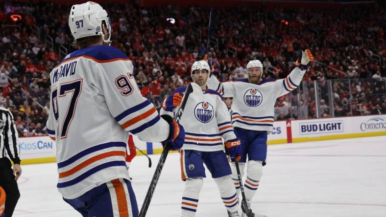 Jan 11, 2024; Detroit, Michigan, USA;  Edmonton Oilers center Connor McDavid (97) receives congratulations from teammates after scoring in the third period against the Detroit Red Wings at Little Caesars Arena. Mandatory Credit: Rick Osentoski-USA TODAY Sports