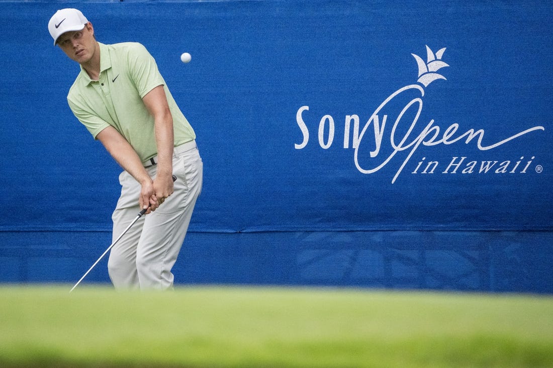 January 11, 2024; Honolulu, Hawaii, USA; Cam Davis hits his chip shot on the 17th hole during the first round of the Sony Open in Hawaii golf tournament at Waialae Country Club. Mandatory Credit: Kyle Terada-USA TODAY Sports