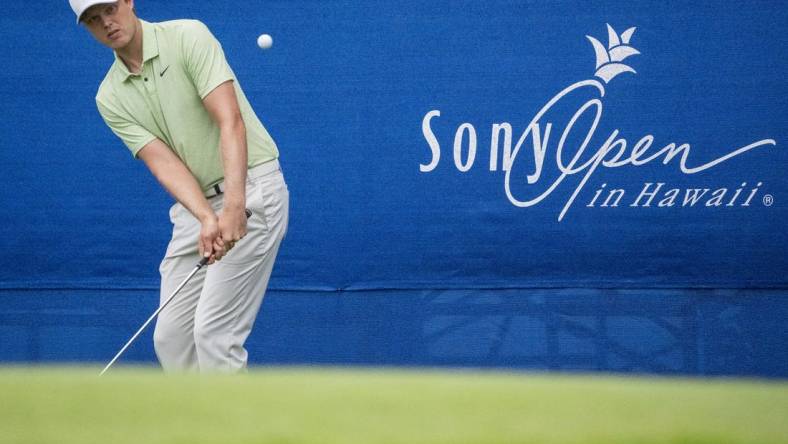 January 11, 2024; Honolulu, Hawaii, USA; Cam Davis hits his chip shot on the 17th hole during the first round of the Sony Open in Hawaii golf tournament at Waialae Country Club. Mandatory Credit: Kyle Terada-USA TODAY Sports