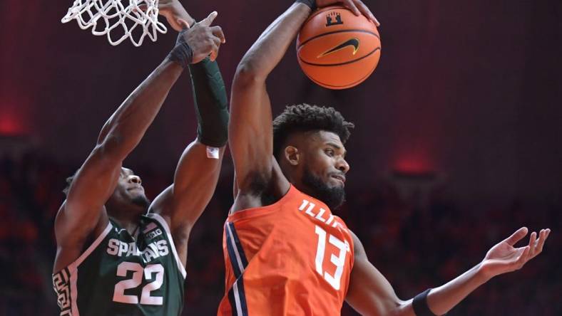 Jan 11, 2024; Champaign, Illinois, USA;  Illinois Fighting Illini forward Quincy Guerrier (13) pulls down a rebound in front of Michigan State Spartans center Mady Sissoko (22) during the second half at State Farm Center. Mandatory Credit: Ron Johnson-USA TODAY Sports