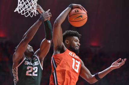 Jan 11, 2024; Champaign, Illinois, USA;  Illinois Fighting Illini forward Quincy Guerrier (13) pulls down a rebound in front of Michigan State Spartans center Mady Sissoko (22) during the second half at State Farm Center. Mandatory Credit: Ron Johnson-USA TODAY Sports