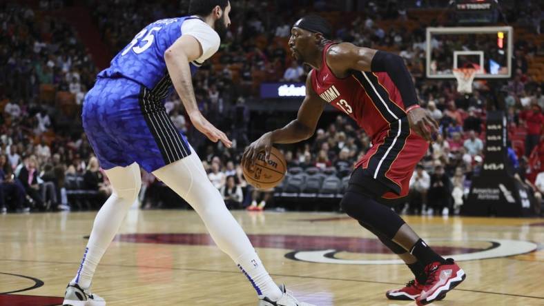 Jan 12, 2024; Miami, Florida, USA; Miami Heat center Bam Adebayo (13) dribbles the basketball as Orlando Magic center Goga Bitadze (35) defends during the first quarter at Kaseya Center. Mandatory Credit: Sam Navarro-USA TODAY Sports