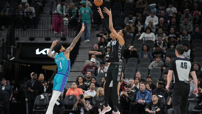 Jan 12, 2024; San Antonio, Texas, USA;  San Antonio Spurs center Victor Wembanyama (1) shoots over Charlotte Hornets center Nick Richards (4) in the first half at Frost Bank Center. Mandatory Credit: Daniel Dunn-USA TODAY Sports