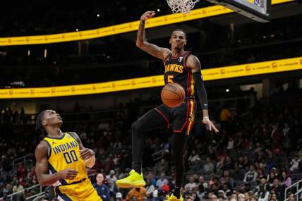 Jan 12, 2024; Atlanta, Georgia, USA; Atlanta Hawks guard Dejounte Murray (5) dunks the ball against the Indiana Pacers during the second half at State Farm Arena. Mandatory Credit: Dale Zanine-USA TODAY Sports