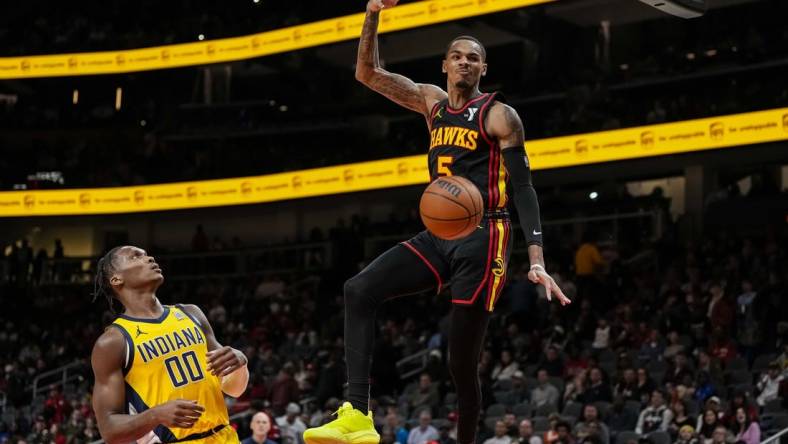 Jan 12, 2024; Atlanta, Georgia, USA; Atlanta Hawks guard Dejounte Murray (5) dunks the ball against the Indiana Pacers during the second half at State Farm Arena. Mandatory Credit: Dale Zanine-USA TODAY Sports