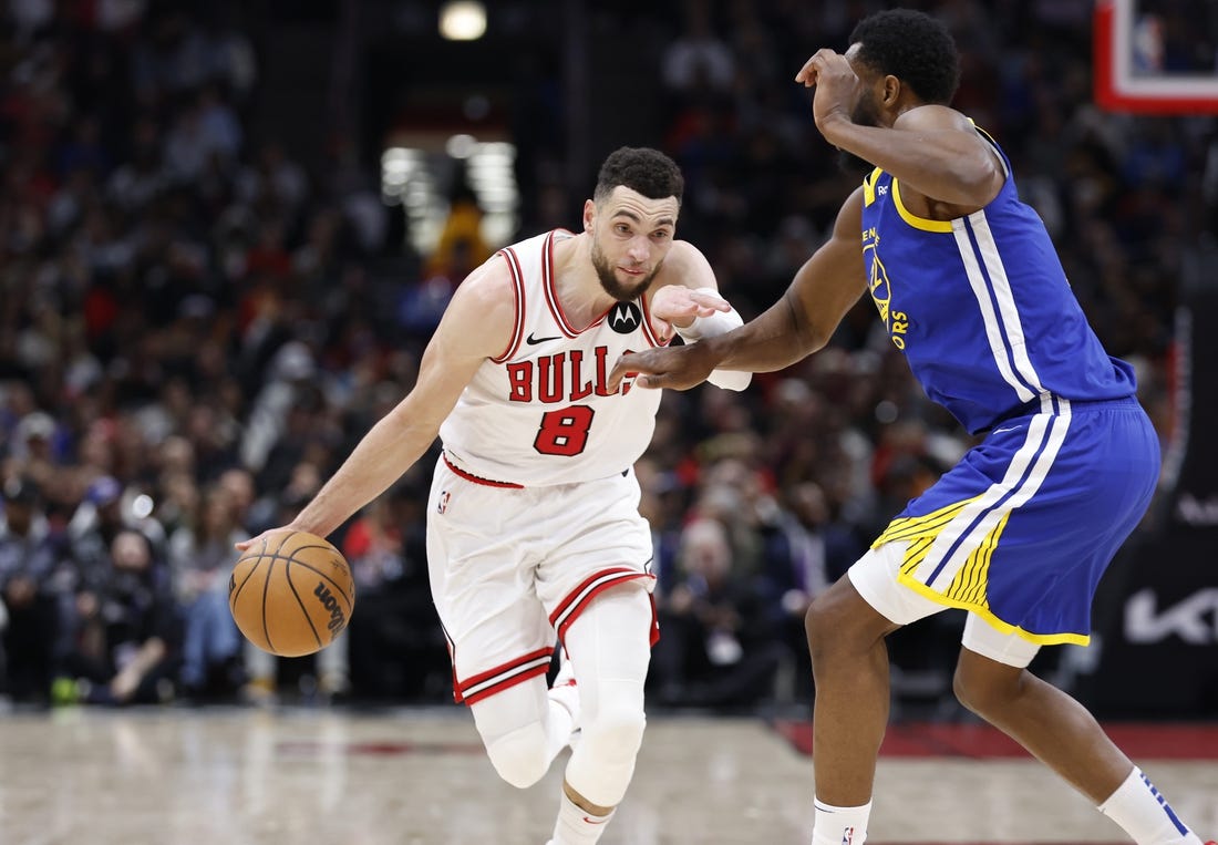Jan 12, 2024; Chicago, Illinois, USA; Chicago Bulls guard Zach LaVine (8) drives against Golden State Warriors forward Andrew Wiggins (22) during the second half at United Center. Mandatory Credit: Kamil Krzaczynski-USA TODAY Sports