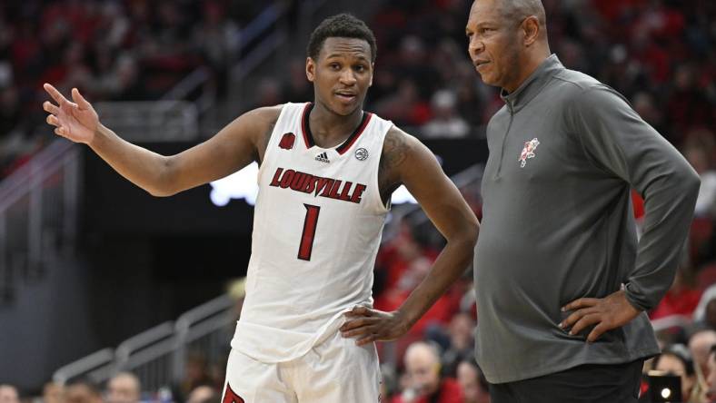 Jan 13, 2024; Louisville, Kentucky, USA;  Louisville Cardinals guard Curtis Williams (1) talks with head coach Kenny Payne during the second half against the North Carolina State Wolfpack at KFC Yum! Center. Mandatory Credit: Jamie Rhodes-USA TODAY Sports