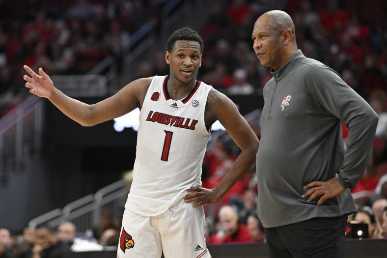 Jan 13, 2024; Louisville, Kentucky, USA;  Louisville Cardinals guard Curtis Williams (1) talks with head coach Kenny Payne during the second half against the North Carolina State Wolfpack at KFC Yum! Center. Mandatory Credit: Jamie Rhodes-USA TODAY Sports