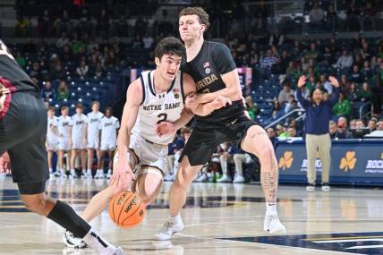 Jan 13, 2024; South Bend, Indiana, USA; Notre Dame Fighting Irish guard Logan Imes (2) drives to the basket as Florida State Seminoles guard Tom House (12) defends in the first half at the Purcell Pavilion. Mandatory Credit: Matt Cashore-USA TODAY Sports