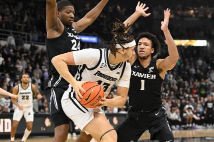 Jan 13, 2024; Providence, Rhode Island, USA; Providence Friars forward Josh Oduro (13) controls the ball against Xavier Musketeers guard Desmond Claude (1) during the first half at Amica Mutual Pavilion. Mandatory Credit:Eric Canha-USA TODAY Sports