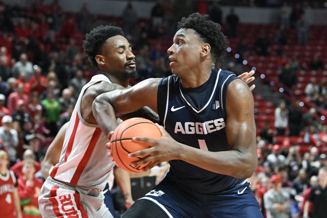 Jan 13, 2024; Las Vegas, Nevada, USA; Utah State Aggies forward Great Osobor (1) drives to the basket against UNLV Rebels forward Kalib Boone (10) in the second half at Thomas & Mack Center. Mandatory Credit: Candice Ward-USA TODAY Sports