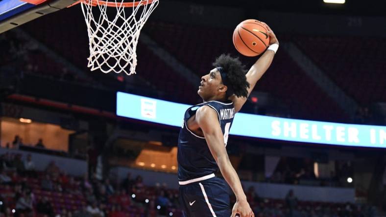 Jan 13, 2024; Las Vegas, Nevada, USA; Utah State Aggies guard Ian Martinez (4) dunks on the UNLV Rebels in the second half at Thomas & Mack Center. Mandatory Credit: Candice Ward-USA TODAY Sports