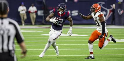 Jan 13, 2024; Houston, Texas, USA; Houston Texans wide receiver Nico Collins (12) runs with the ball during the second quarter in a 2024 AFC wild card game at NRG Stadium. Mandatory Credit: Thomas Shea-USA TODAY Sports
