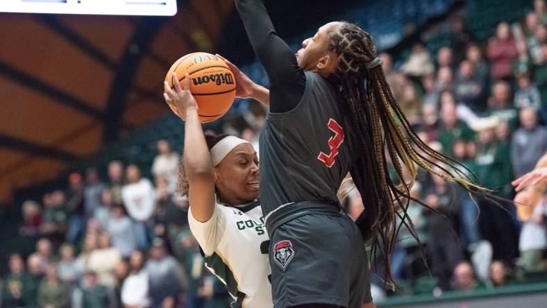 Colorado State women's basketball player Cailyn Crocker (32) is defended by Lobos guard Nyah Wilson (3) during a game against New Mexico on Saturday, January 13, 2024, at Moby Arena in Fort Collins, Colo.