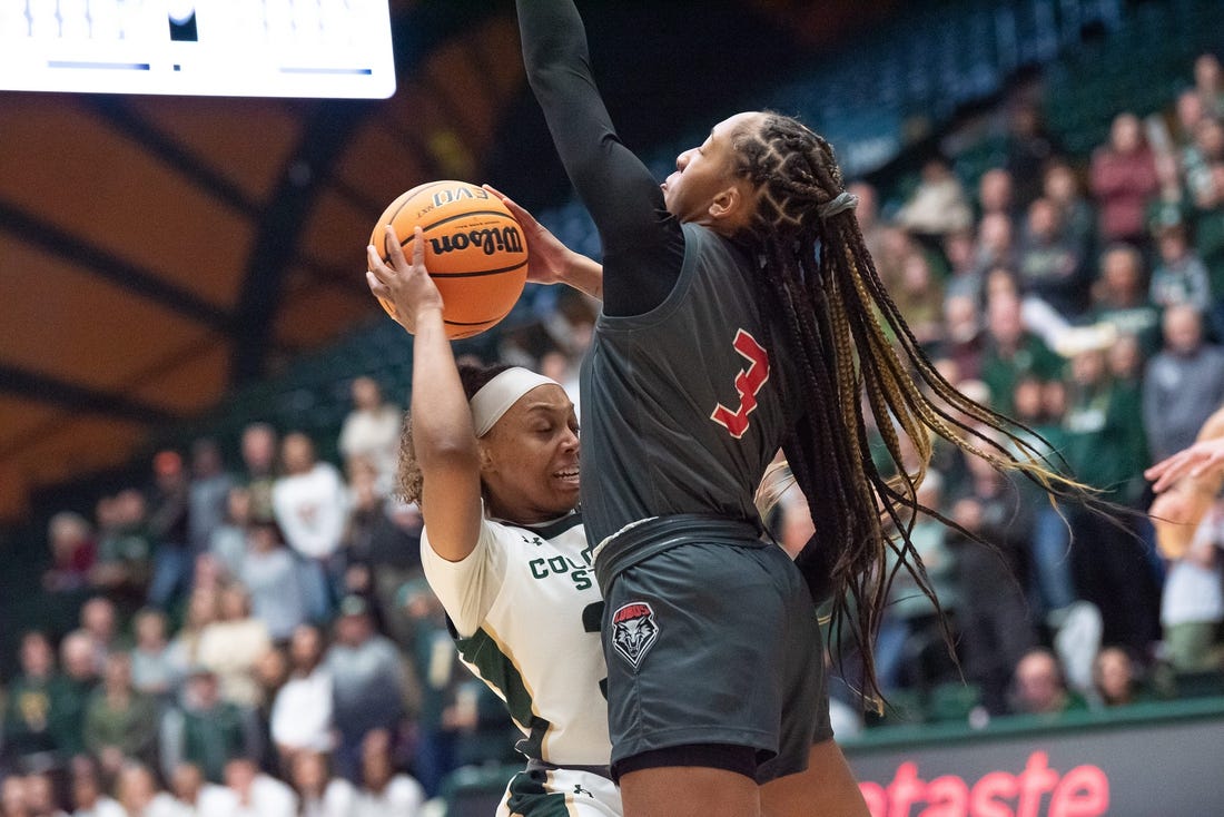 Colorado State women's basketball player Cailyn Crocker (32) is defended by Lobos guard Nyah Wilson (3) during a game against New Mexico on Saturday, January 13, 2024, at Moby Arena in Fort Collins, Colo.