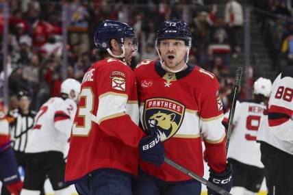 Jan 13, 2024; Sunrise, Florida, USA; Florida Panthers center Sam Reinhart (13) celebrates with center Carter Verhaeghe (23) after scoring against the New Jersey Devils during the second period at Amerant Bank Arena. Mandatory Credit: Sam Navarro-USA TODAY Sports